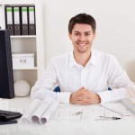 Confident young architect in his office