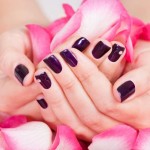 Woman with beautiful nails holding petals
