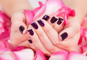 Woman with beautiful nails holding petals