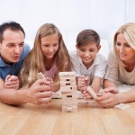 Happy Family Playing With The Wooden Blocks
