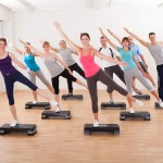 Class doing aerobics balancing on boards