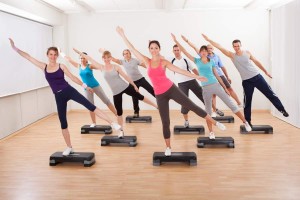 Class doing aerobics balancing on boards